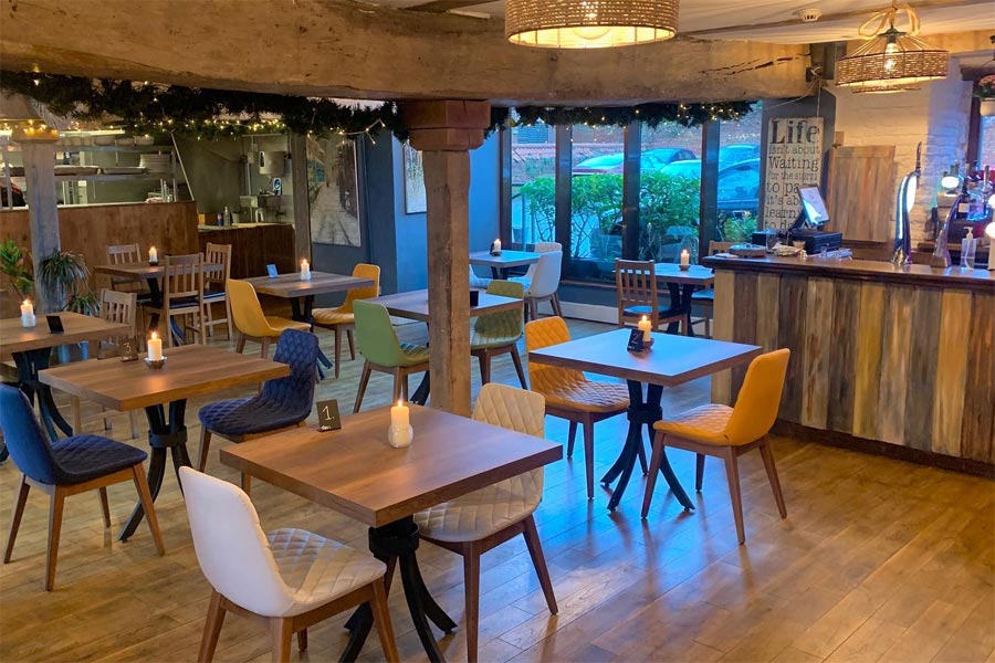 Tables and chairs inside the warehouse restaurant