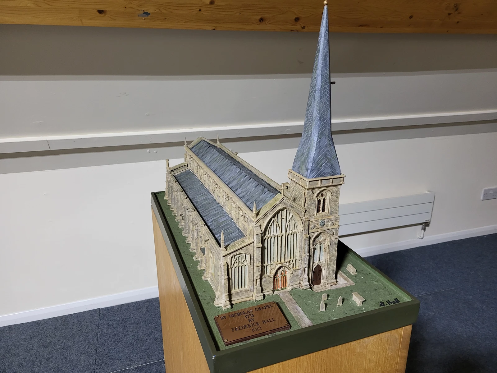Scale model of a church with a tall spire